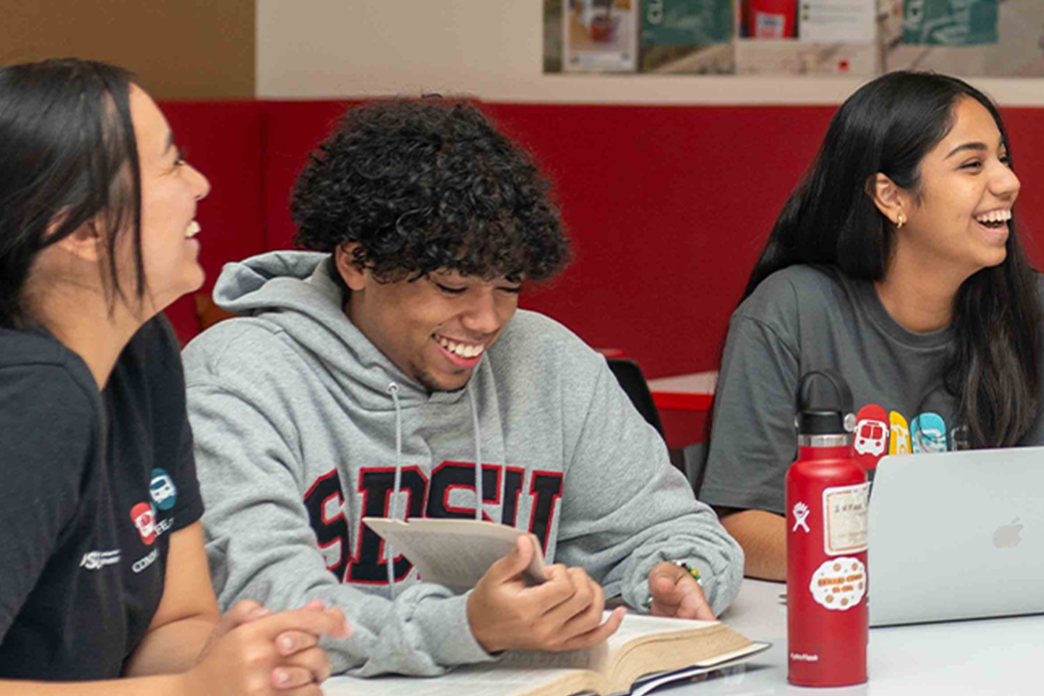 people sitting at table and laughing