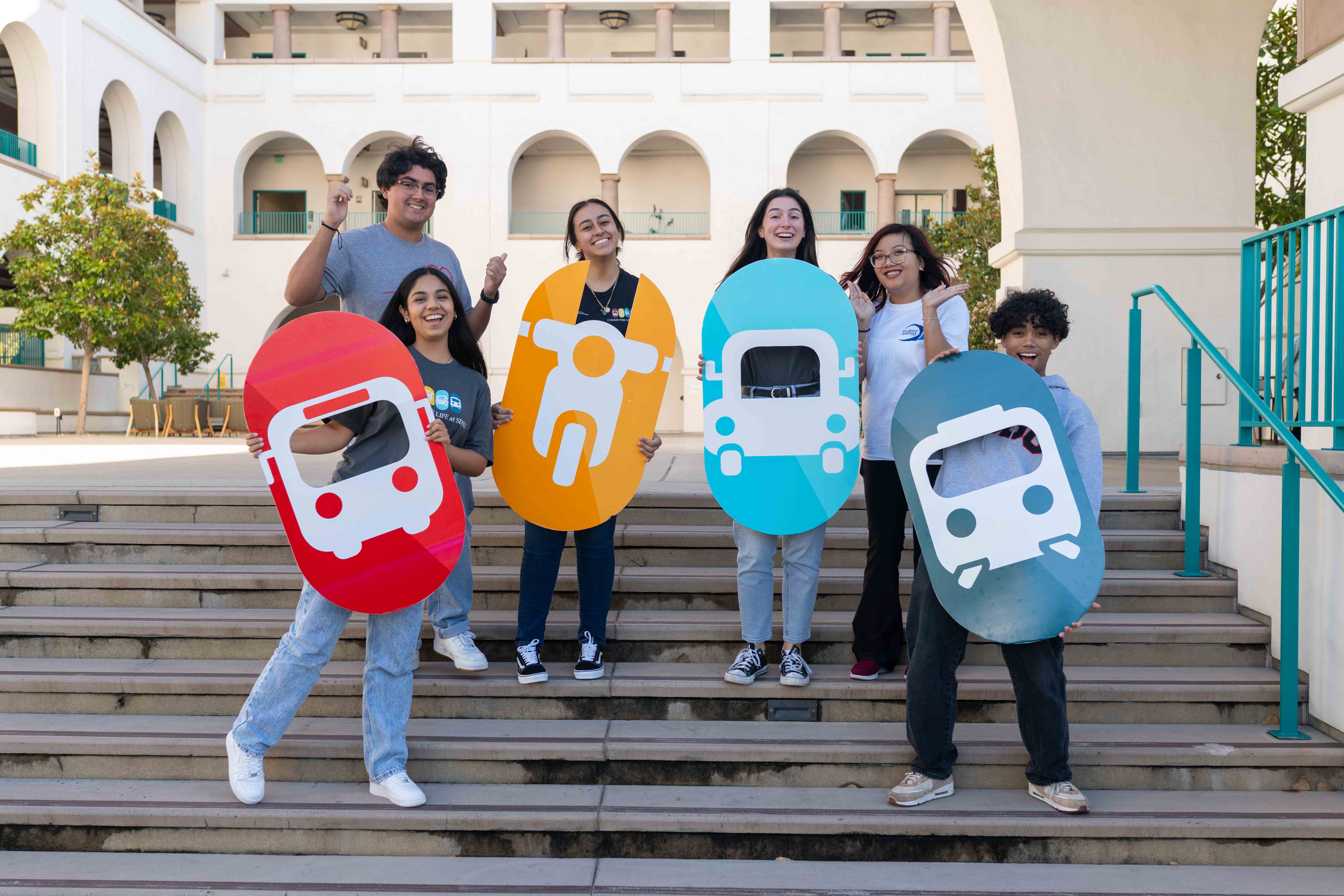 students holding poster images of transportation vehicles